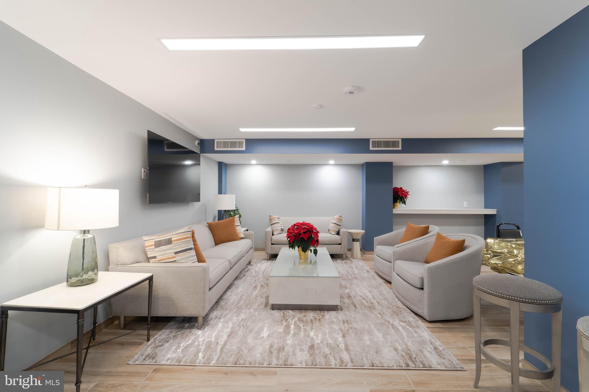 1808 Old Meadow Road, Unit 805 McLean, VA 22102 - Photo 52 of 58 a living room with furniture and a lamp