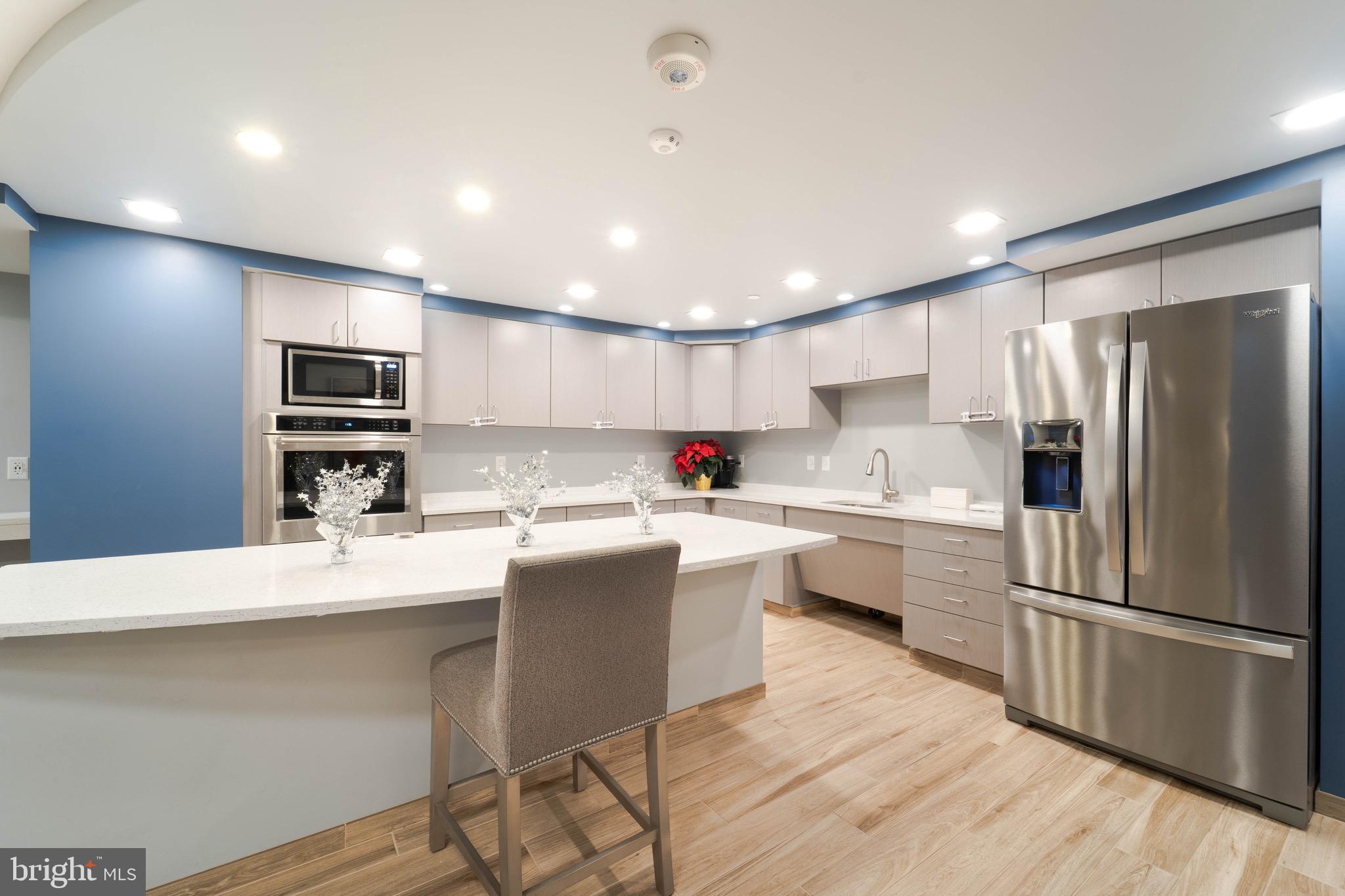 1808 Old Meadow Road, Unit 805 McLean, VA 22102 - Photo 53 of 58 a kitchen with stainless steel appliances a refrigerator stove microwave and cabinets