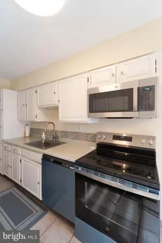 a kitchen with stainless steel appliances granite countertop a stove and a sink
