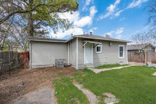 a backyard of a house with yard and barbeque oven