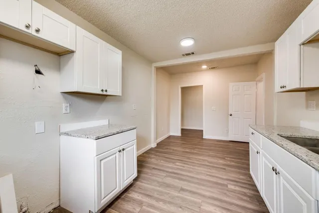 a kitchen with a sink and cabinets