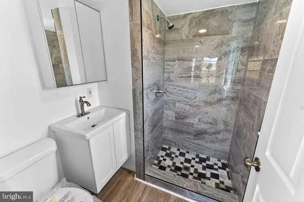 a bathroom with a sink toilet and shower