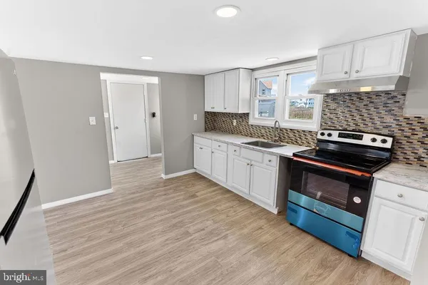 a kitchen with a sink stove and cabinets