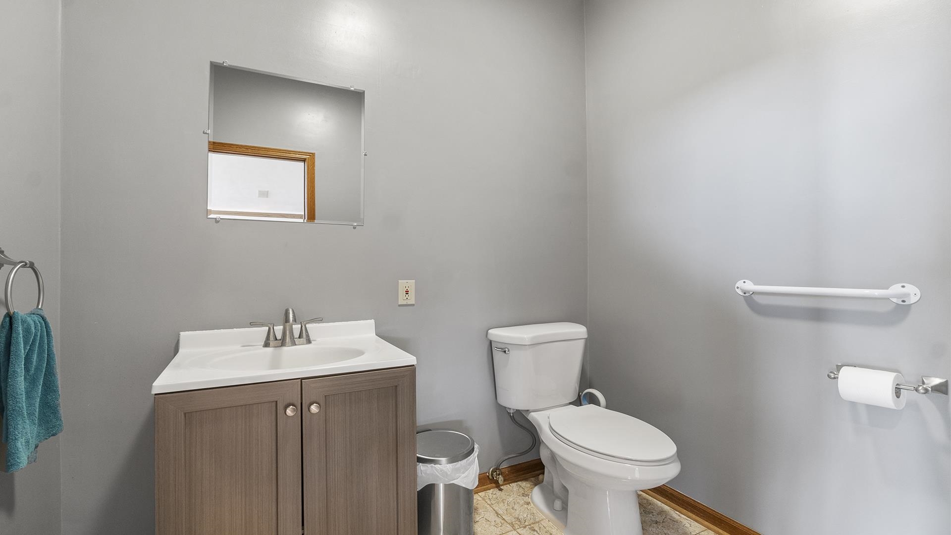 7674 West Pines Road Polo, IL 61064 - Photo 16 of 60 a bathroom with a toilet sink and mirror