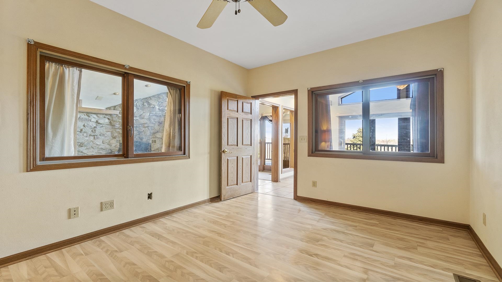 7674 West Pines Road Polo, IL 61064 - Photo 20 of 60 a view of an empty room with a window and wooden floor
