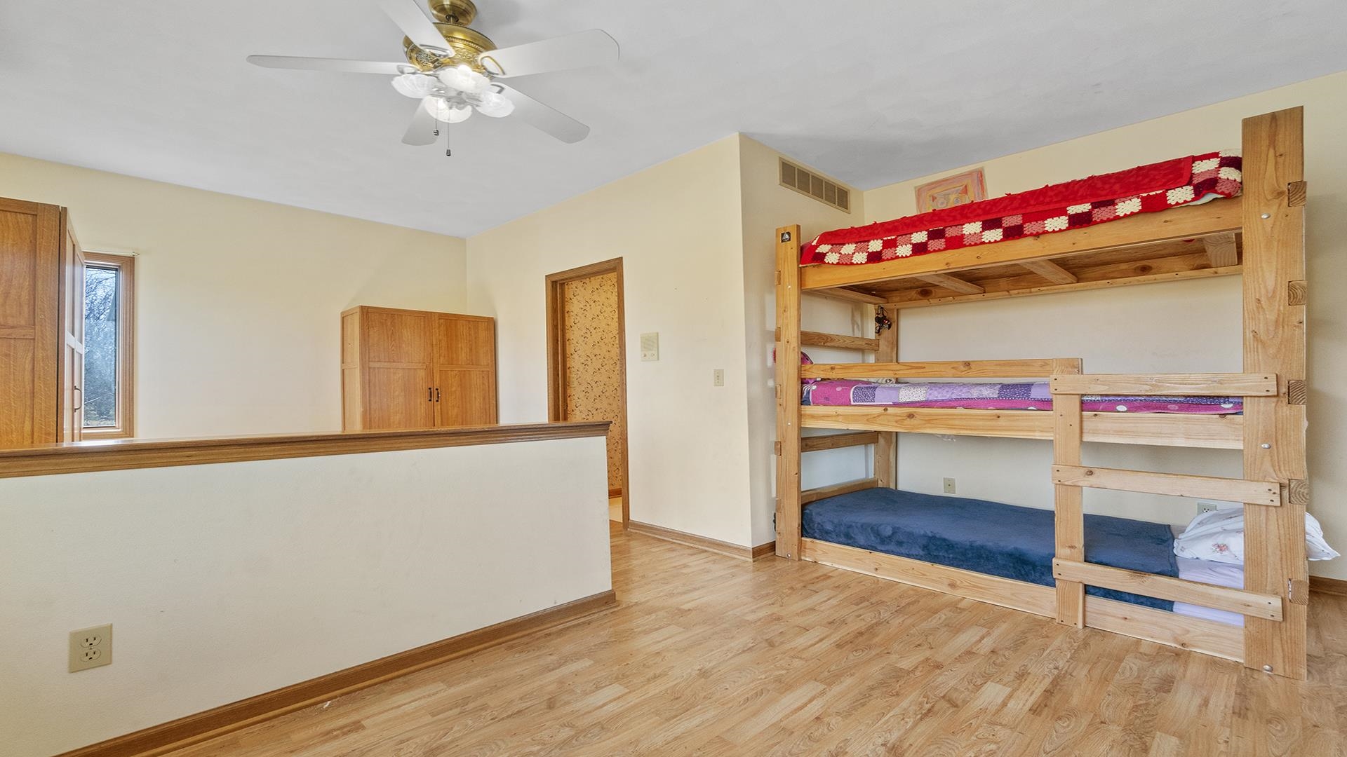 7674 West Pines Road Polo, IL 61064 - Photo 25 of 60 a view of an empty room with wooden floor and fan