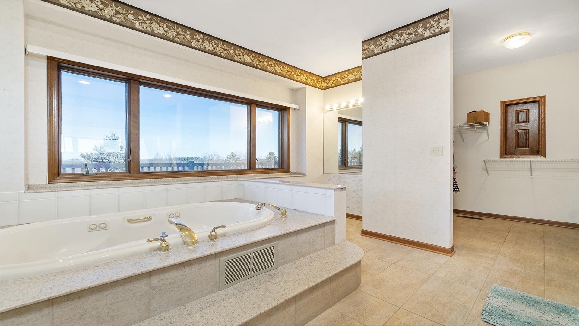 7674 West Pines Road Polo, IL 61064 - Photo 35 of 60 a bathroom with a bathtub and a shower