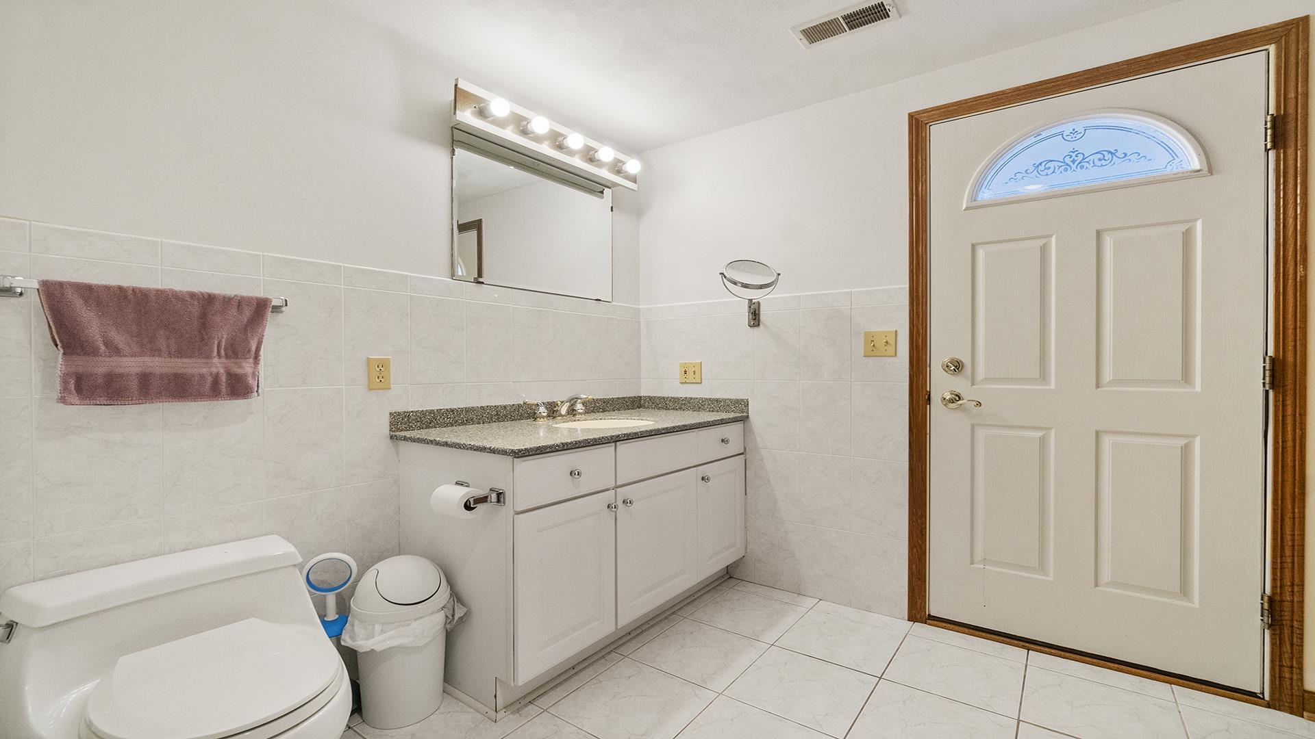 7674 West Pines Road Polo, IL 61064 - Photo 42 of 60 a bathroom with a granite countertop toilet sink and mirror