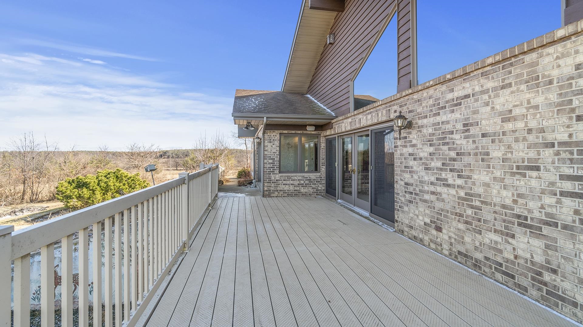 7674 West Pines Road Polo, IL 61064 - Photo 50 of 60 a view of a balcony with wooden floor and fence
