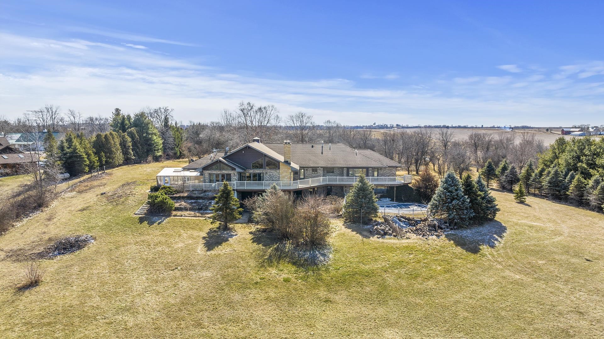 7674 West Pines Road Polo, IL 61064 - Photo 55 of 60 an aerial view of a house with swimming pool and mountains in the background