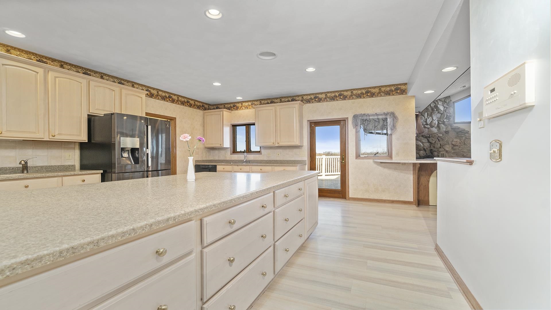 7674 West Pines Road Polo, IL 61064 - Photo 8 of 60 a kitchen with granite countertop a refrigerator and a stove top oven