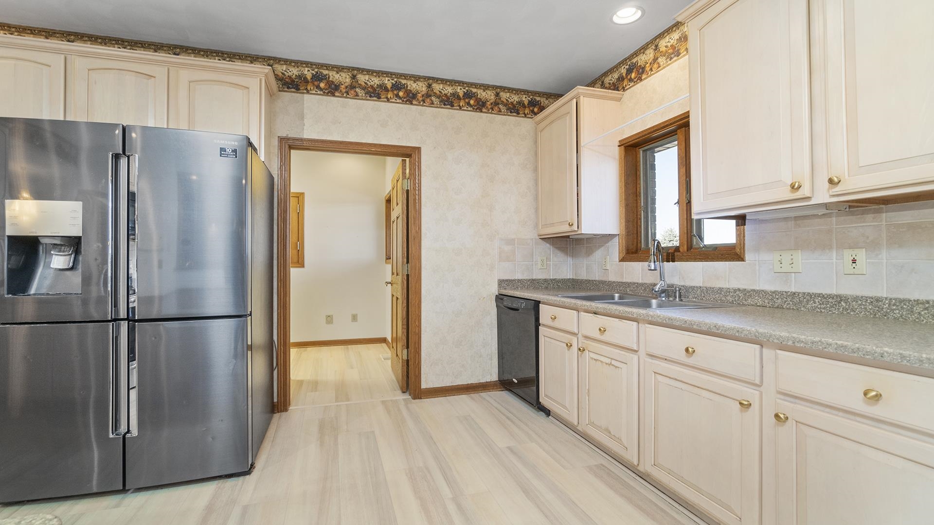 7674 West Pines Road Polo, IL 61064 - Photo 9 of 60 a kitchen with granite countertop a refrigerator a sink and white cabinets