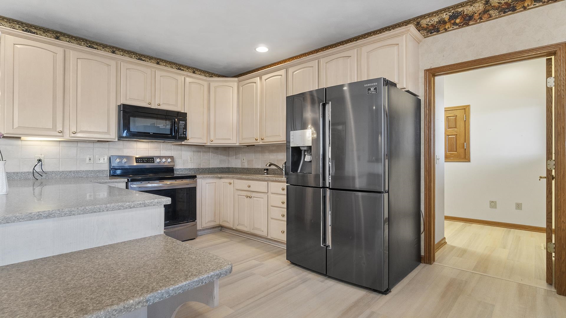 7674 West Pines Road Polo, IL 61064 - Photo 10 of 60 a kitchen with a refrigerator a microwave a sink and cabinets