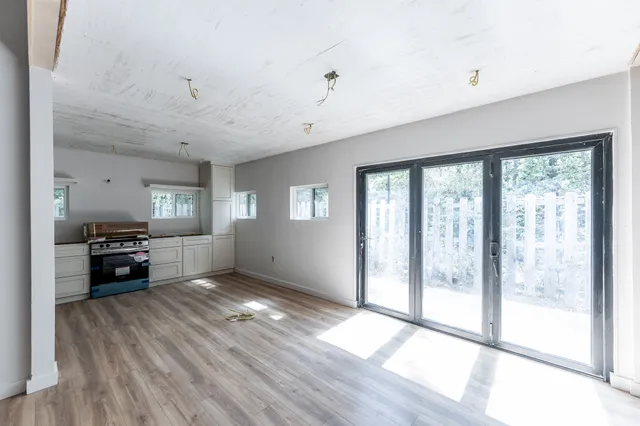 a living room with furniture and large windows