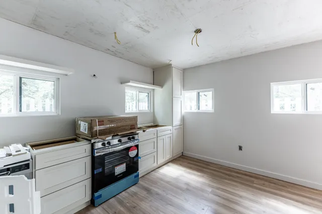 a kitchen with granite countertop a stove and a refrigerator