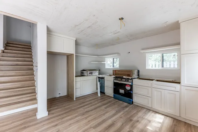 a kitchen with a refrigerator and a stove top oven
