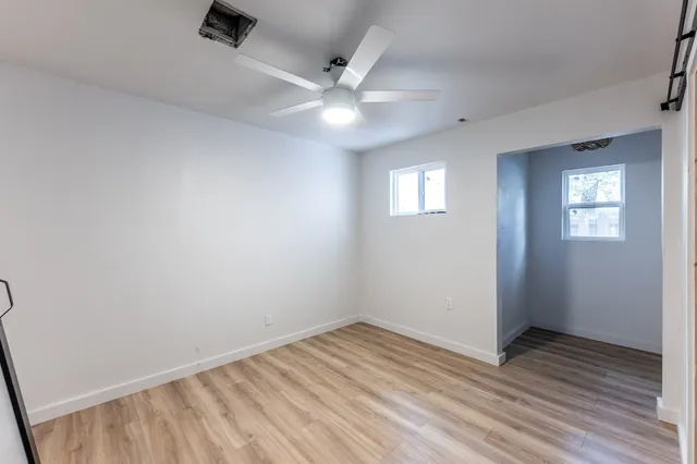 wooden floor in an empty room with a window