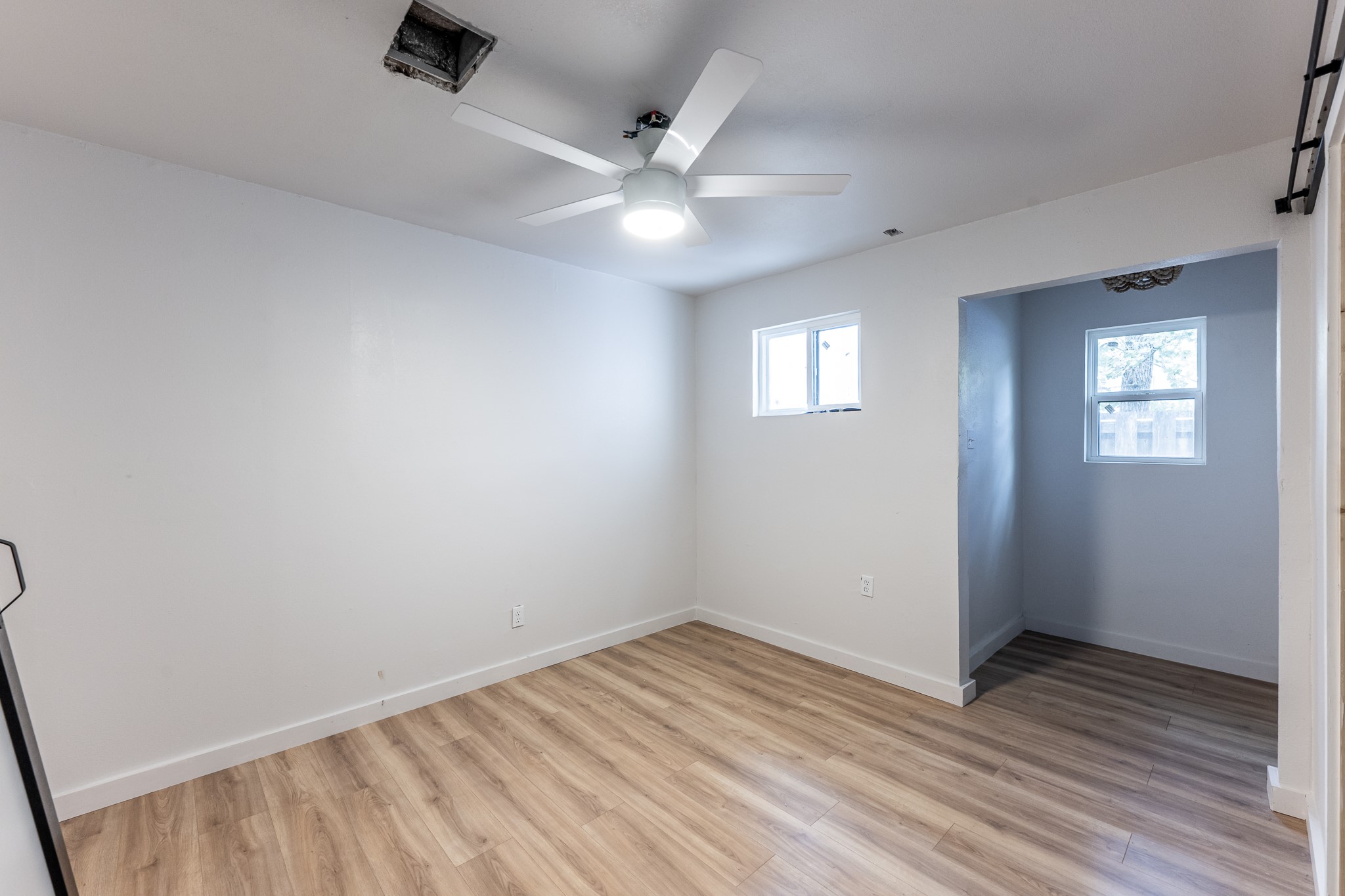 28600 Rantoul Court Point Blank, TX 77364 - Photo 18 of 33 wooden floor in an empty room with a window