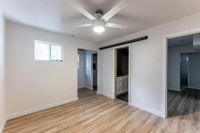a view of an empty room with wooden floor