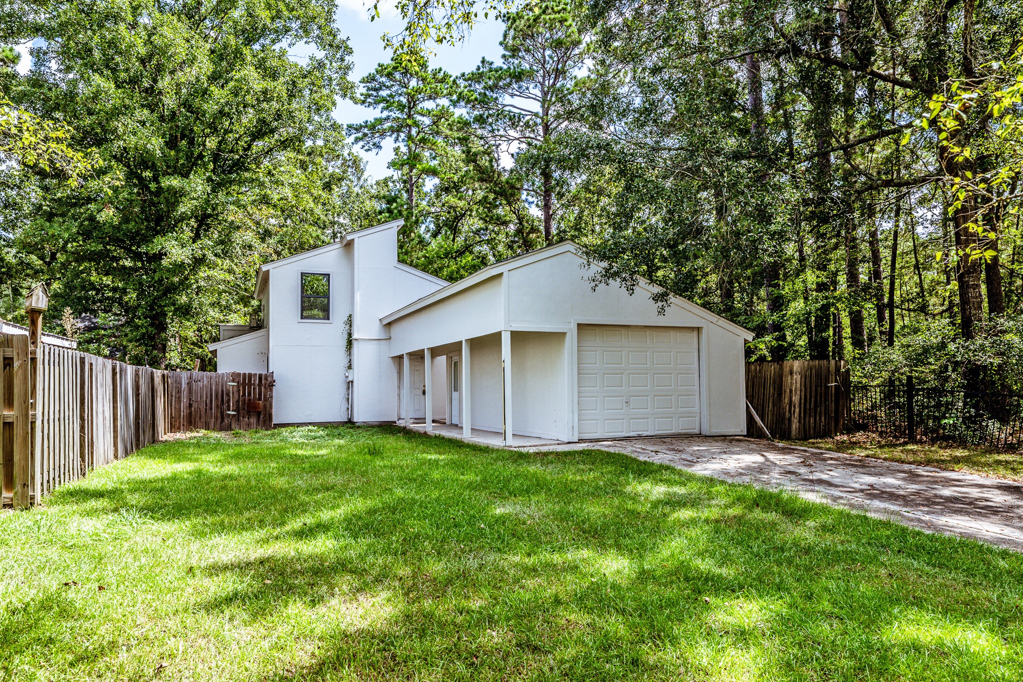 28600 Rantoul Court Point Blank, TX 77364 - Photo 2 of 33 a view of a backyard with a small cabin and wooden fence