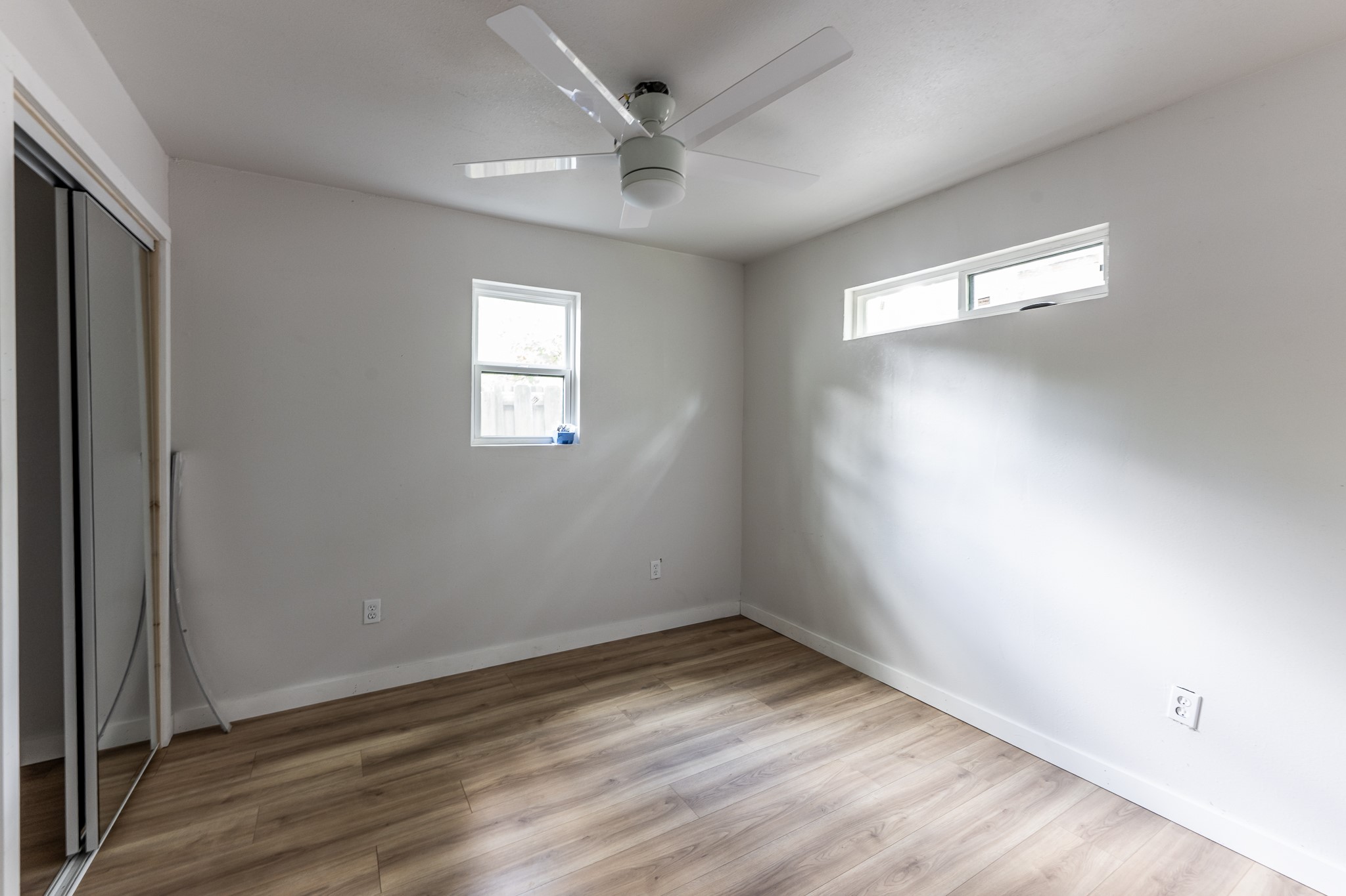 28600 Rantoul Court Point Blank, TX 77364 - Photo 24 of 33 an empty room with wooden floor and windows