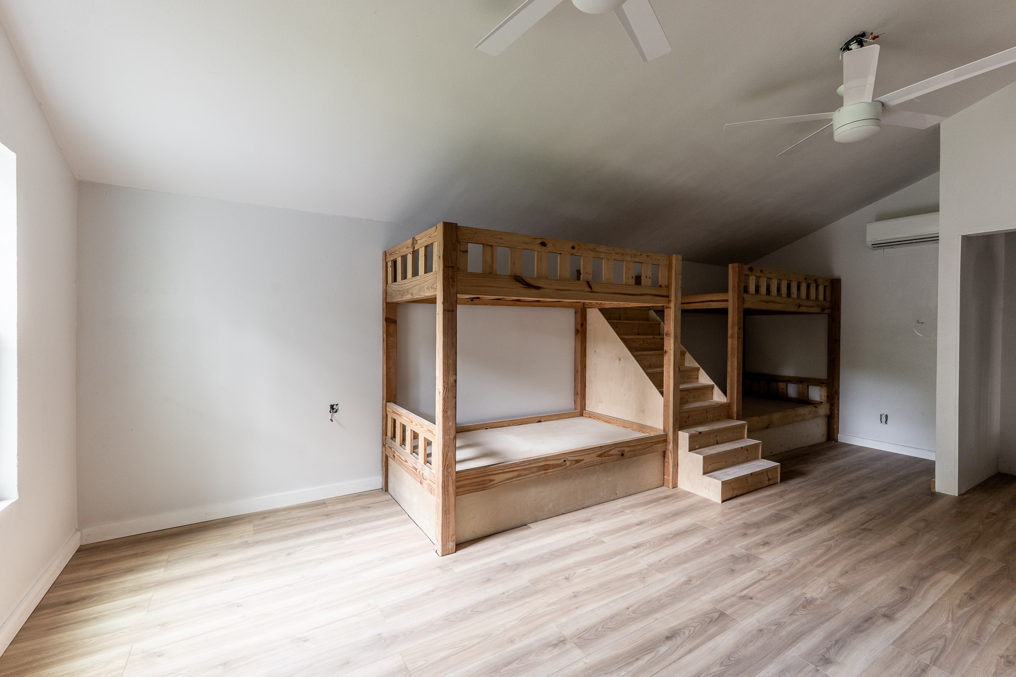 28600 Rantoul Court Point Blank, TX 77364 - Photo 30 of 33 an empty room with wooden floor stairs and a window
