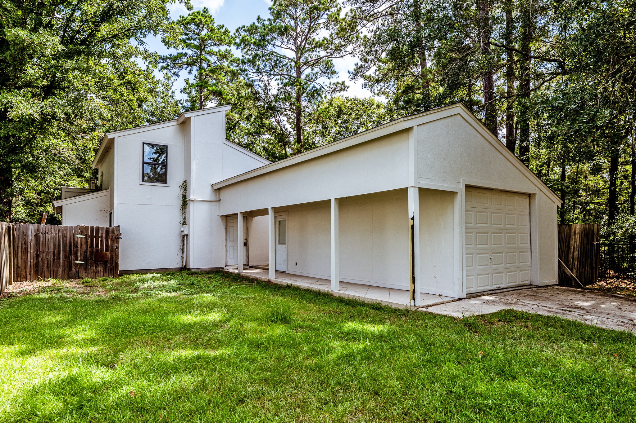 28600 Rantoul Court Point Blank, TX 77364 - Photo 3 of 33 a backyard of a house with lots of plants and tree