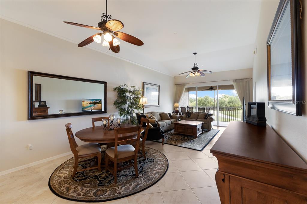 7179 Boca Grove Place, Unit 202 Lakewood Ranch, FL 34202 - Photo 11 of 46 a living room with furniture and a large window
