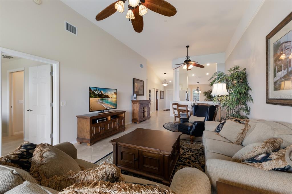 7179 Boca Grove Place, Unit 202 Lakewood Ranch, FL 34202 - Photo 15 of 46 a living room with furniture and a flat screen tv