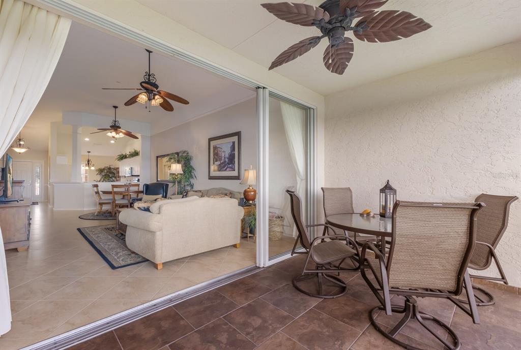 7179 Boca Grove Place, Unit 202 Lakewood Ranch, FL 34202 - Photo 18 of 46 a living room with furniture and a chandelier