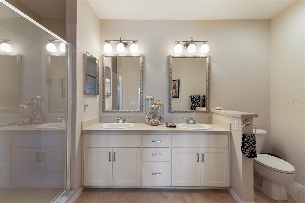 7179 Boca Grove Place, Unit 202 Lakewood Ranch, FL 34202 - Photo 23 of 46 a bathroom with a double vanity sink mirror and toilet