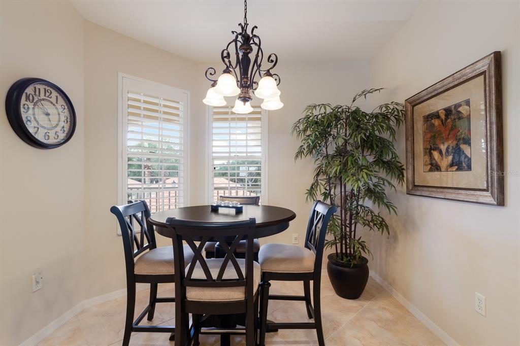 7179 Boca Grove Place, Unit 202 Lakewood Ranch, FL 34202 - Photo 10 of 46 a dining room with furniture and window