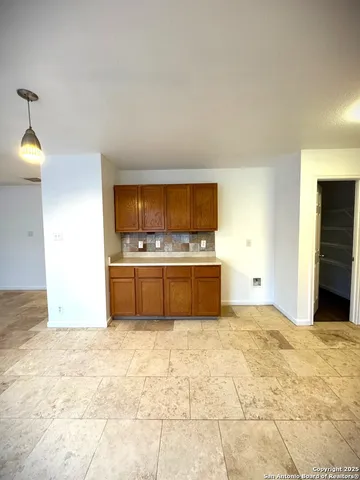 a view of kitchen with cabinets