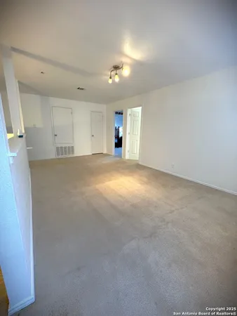 an empty room with a kitchen and a sink