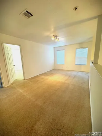 a view of an empty room and a window