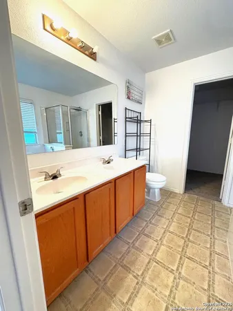 a bathroom with a sink a mirror and a toilet