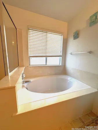 a bath tub sitting in a bathroom next to a window