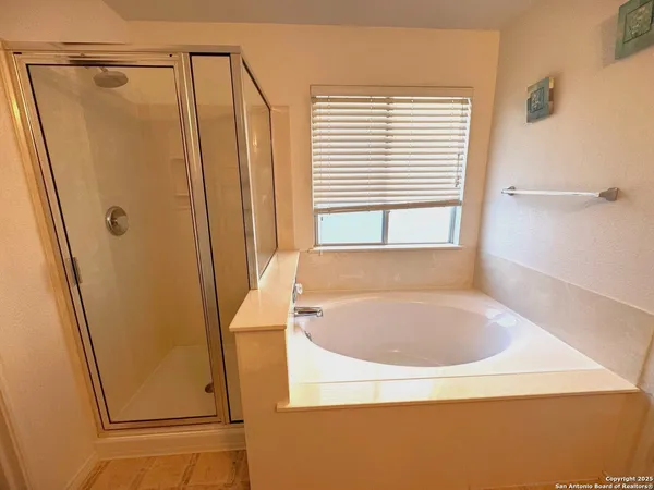 a bathroom with a tub and a shower