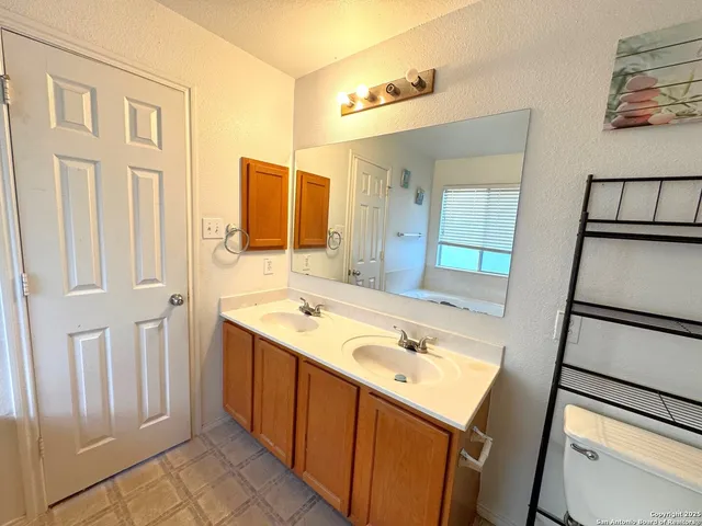 a bathroom with a sink a toilet and mirror