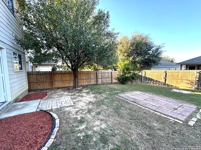 a view of a backyard with large trees