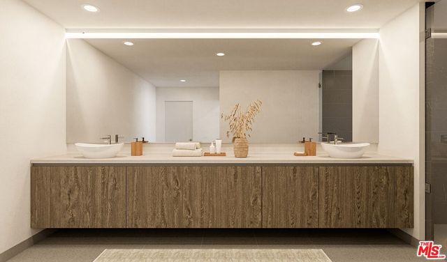 a bathroom with a sink double vanity and mirror