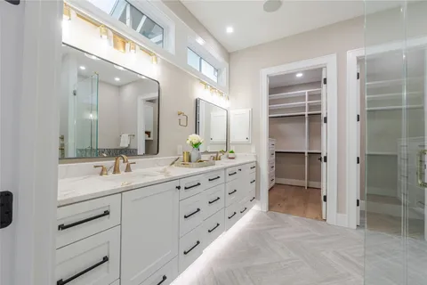 a bathroom with a double vanity sink mirror and double