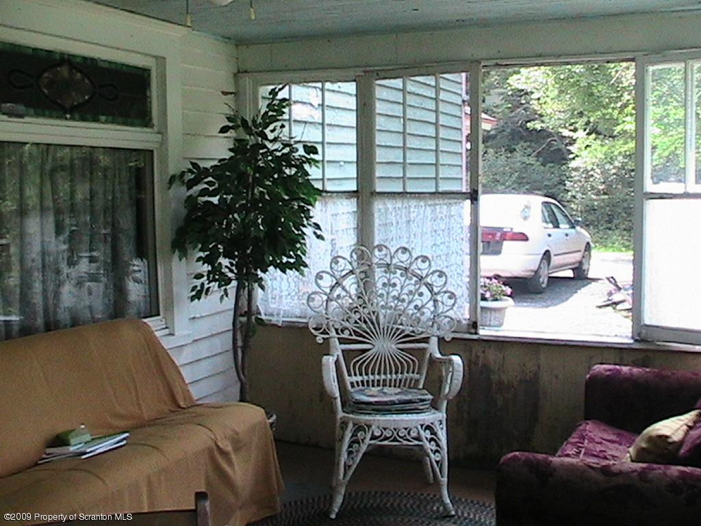 74 North Main Street Nicholson, PA 18446 - Photo 3 of 5 a living room with furniture and a potted plant