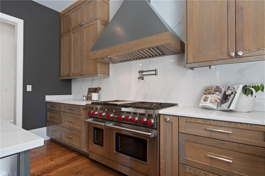 1285 Stuart Ridge Johns Creek, GA 30022 - Photo 25 of 89 a kitchen with stainless steel appliances granite countertop a stove and a microwave