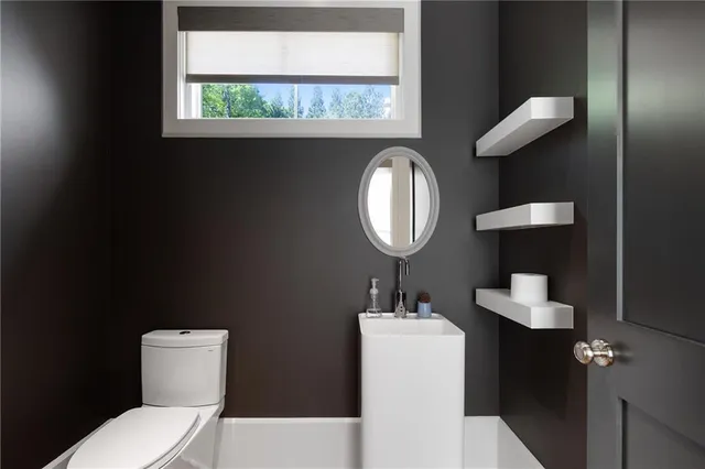 a bathroom with a sink toilet vanity tub and shower