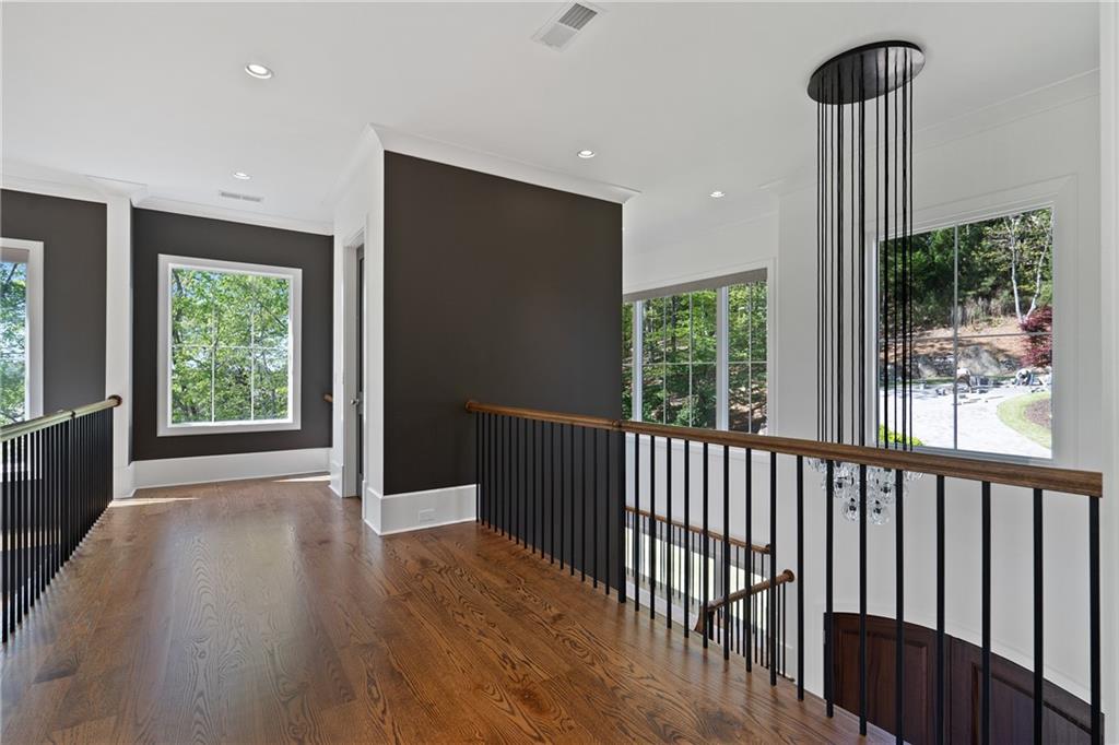 1285 Stuart Ridge Johns Creek, GA 30022 - Photo 37 of 89 a view of hallway with a large window and wooden floor
