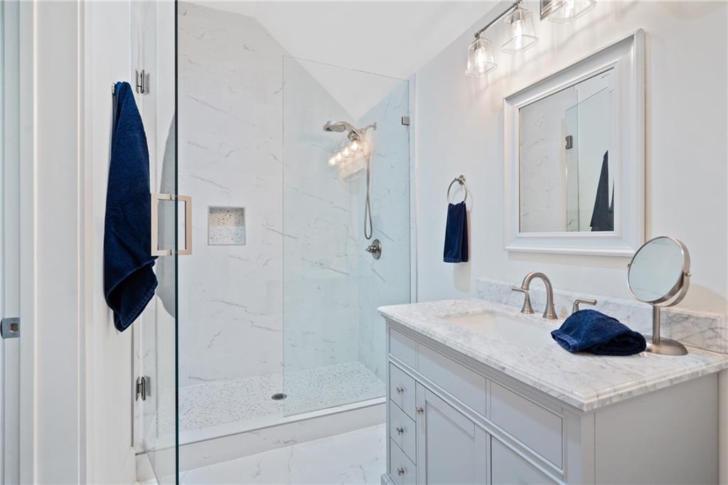 1285 Stuart Ridge Johns Creek, GA 30022 - Photo 60 of 89 a bathroom with a sink and a mirror