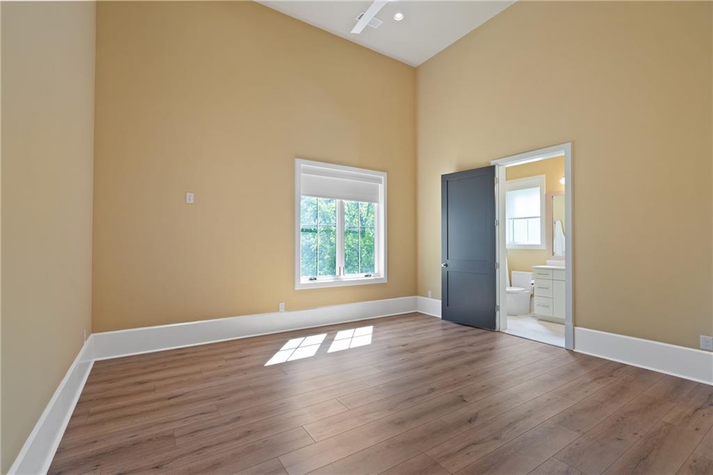 1285 Stuart Ridge Johns Creek, GA 30022 - Photo 66 of 89 a view of an empty room with wooden floor and a window