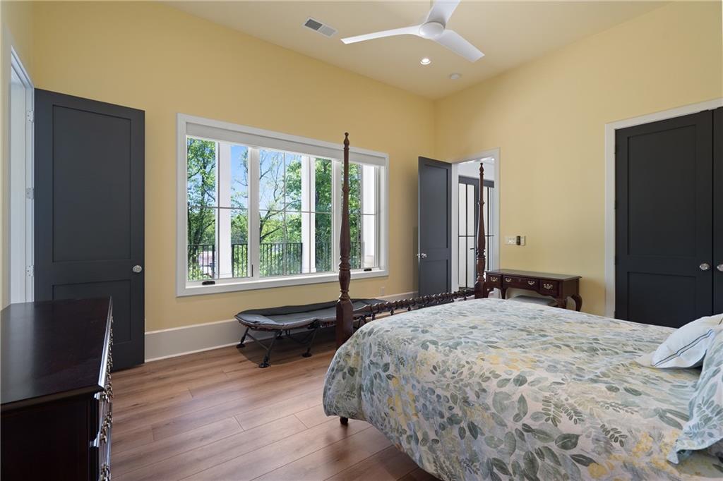 1285 Stuart Ridge Johns Creek, GA 30022 - Photo 70 of 89 a bedroom with a bed closet and a large window
