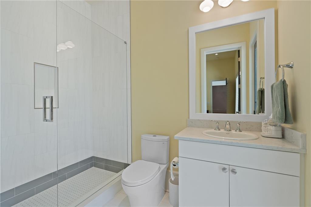 1285 Stuart Ridge Johns Creek, GA 30022 - Photo 71 of 89 a bathroom with a granite countertop sink a toilet and a mirror